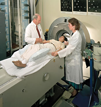 Pioneering research in the 1970s led to this PET scanner, shown with Thomas Budinger, Anna Hashima, and Judy Blair (1988).